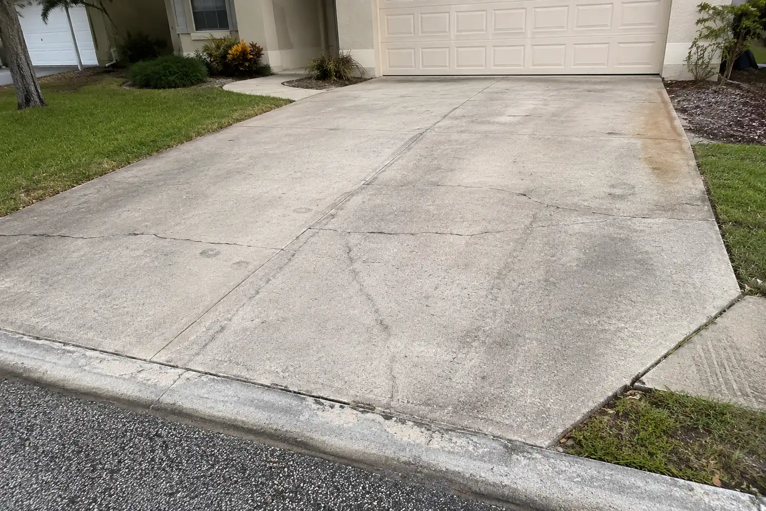 Cracked and stained concrete driveway